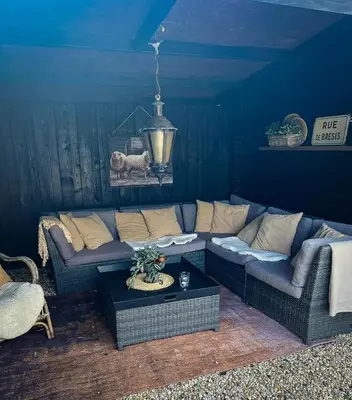 a living room with a couch and a table at De Koolschuur in Heerhugowaard