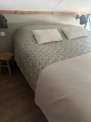 a bed with two pillows on it in a room at De Koolschuur in Heerhugowaard