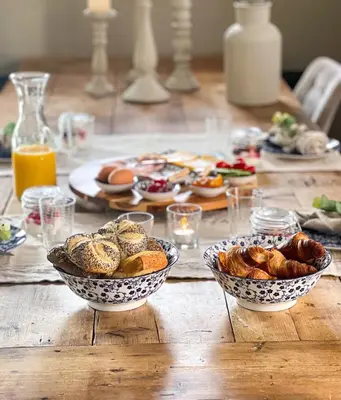a wooden table with two bowls of pastries on it at De Koolschuur in Heerhugowaard