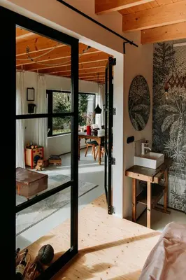 a room with a glass door leading into a bedroom at Sfeervol Vakantiehuis - Badkuip met weids uitzicht - Markermeer - by Familie Buitenhuys holiday houses in Oosterleek