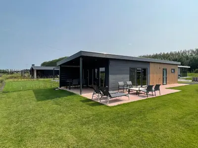 a building with chairs and tables in a yard at Miva in Leiderdorp