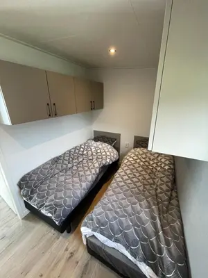two beds in a small room with cabinets at Miva in Leiderdorp