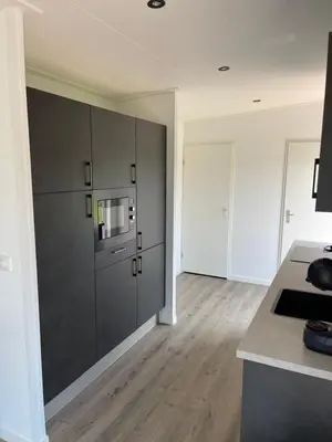 a kitchen with black cabinets and a counter top at Miva in Leiderdorp