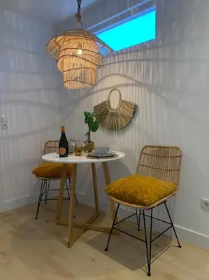 a dining room with a table and two chairs at Faya Beachhouse in Noordwijk aan Zee