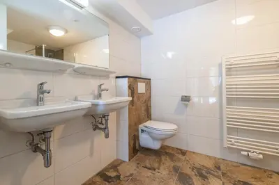 a bathroom with two sinks and a toilet at Plantage Garden Apartments in Amsterdam