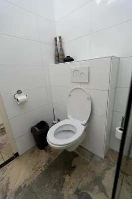 a bathroom with a white toilet in a stall at Plantage Garden Apartments in Amsterdam