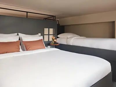two beds sitting next to each other in a bedroom at YAYS Amsterdam Maritime by Numa in Amsterdam