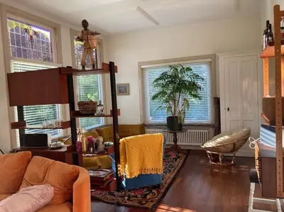 a living room with a couch and a chair at Villa Bollenstreek in Hillegom
