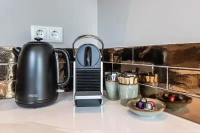 a tea kettle on a counter next to a mixer at Luxury Watervilla Near Amsterdam And Schiphol in Aalsmeer