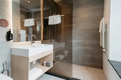 a bathroom with a sink and a shower at Leerhotel Het Klooster in Amersfoort