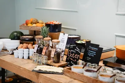 a wooden table with food and ingredients on it at Leerhotel Het Klooster in Amersfoort