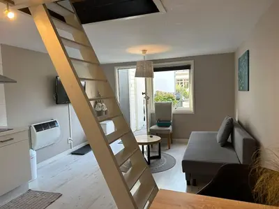 a living room with a staircase in a tiny house at Garden house, Free parking in Zandvoort