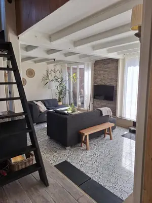 a living room with a couch and a table at Rekerlanden 46 in Warmenhuizen