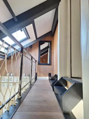 a hallway of a building with a wooden walkway at Rekerlanden 46 in Warmenhuizen