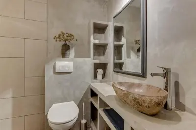 a bathroom with a bowl sink and a toilet at Rekerlanden 46 in Warmenhuizen