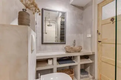 a bathroom with a sink and a mirror and a toilet at Rekerlanden 46 in Warmenhuizen