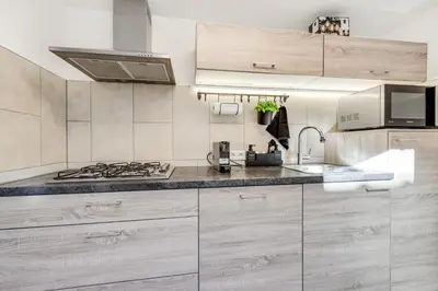 a kitchen with a sink and a stove top oven at Dorpsgeluk centrum Uitgeest in Uitgeest