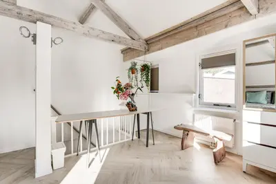 a dining room with a table and a window at Dorpsgeluk centrum Uitgeest in Uitgeest