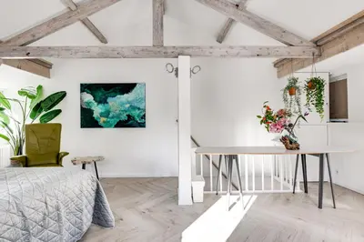 a bedroom with a bed and a desk at Dorpsgeluk centrum Uitgeest in Uitgeest