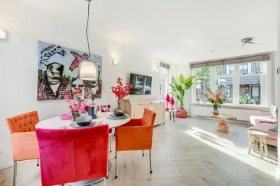 a living room with a table and chairs at Dorpsgeluk centrum Uitgeest in Uitgeest