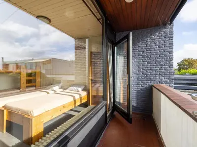 a bed on the balcony of a house at De Kaag Watersport Groepsaccommodatie - 80 pers in Kaag