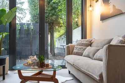 a living room with a couch and a glass table at The Green Pine Tree in Zandvoort