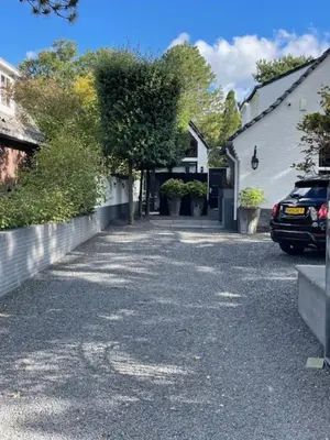 a street with a car parked next to a house at The Green Pine Tree in Zandvoort
