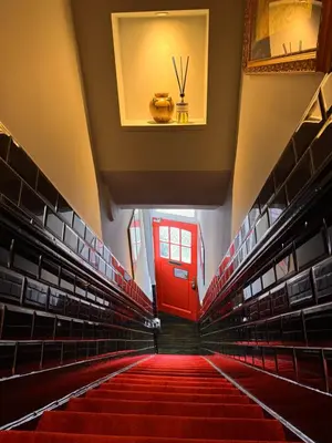 a hallway with a red door and red stairs in an auditorium at Décor Canal House in Amsterdam