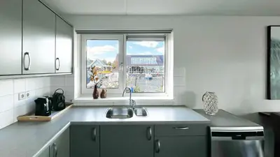 a kitchen with a sink and a window at Droomzicht by Droomvilla in Uitgeest