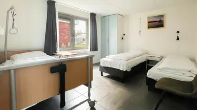 a hospital room with two beds and a window at Droomzicht by Droomvilla in Uitgeest