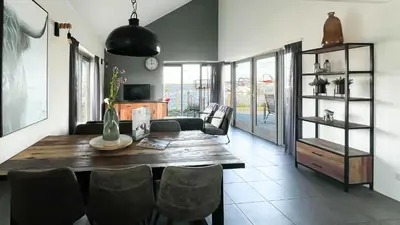 a dining room with a table and chairs at Droomzicht by Droomvilla in Uitgeest