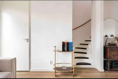 a living room with a staircase and a couch at 120m2 Spacious 4-bedroom Apartment with Roofterras in Amsterdam