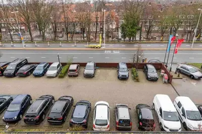 a bunch of cars parked in a parking lot at 120m2 Spacious 4-bedroom Apartment with Roofterras in Amsterdam