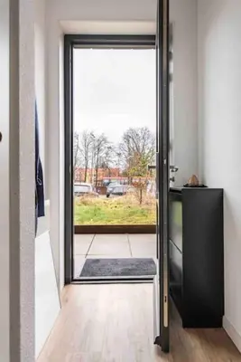 a door to a room with a view of a yard at 120m2 Spacious 4-bedroom Apartment with Roofterras in Amsterdam