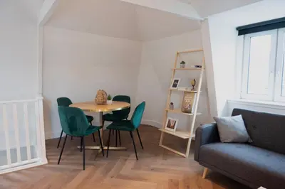 a living room with a table and chairs and a couch at PURMERENT Apartments in Purmerend