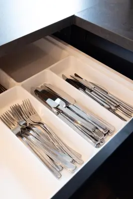 a drawer filled with silver utensils in a kitchen at PURMERENT Apartments in Purmerend