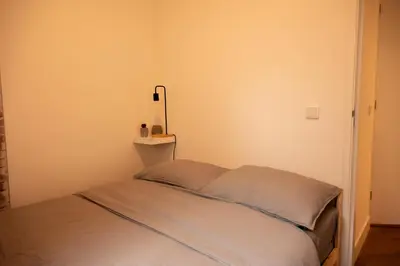 a bed in a small room with aermottermottermott at PURMERENT Apartments in Purmerend