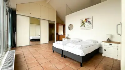 a bedroom with a large bed in a room at Sterrenzicht by Droomvilla in Uitgeest