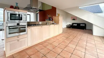 a large kitchen with a stove and a microwave at Sterrenzicht by Droomvilla in Uitgeest