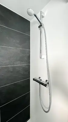 a shower with a shower head in a bathroom at Golfzicht by Droomvilla in Uitgeest