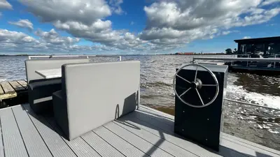 a dock with a door on the side of a boat at Prachtzicht by Droomvilla in Uitgeest