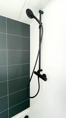 a shower with a shower head in a bathroom at Prachtzicht by Droomvilla in Uitgeest