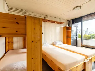 two bunk beds in a room with a window at De Kaag Watersport Groepsaccommodatie - 30 pers in Kaag