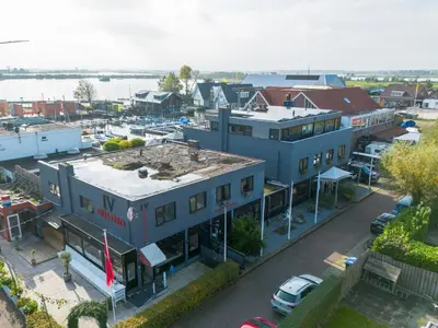 an aerial view of a building with a marina at De Kaag Watersport Groepsaccommodatie - 50 pers in Kaag