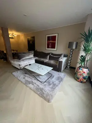a living room with a couch and a table at Villa B&B Bovenkarspel in Bovenkarspel