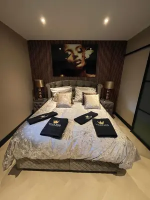 a bedroom with a large bed with pillows on it at Villa B&B Bovenkarspel in Bovenkarspel