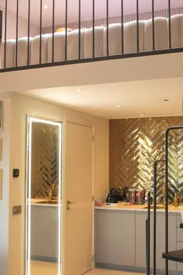 a loft bed in a room with a kitchen at Villa B&B Bovenkarspel in Bovenkarspel
