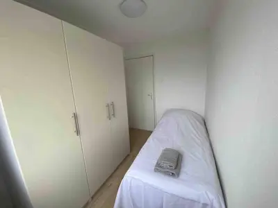 a room with a bed with a book on it at Nice Spacious House Near Amsterdam And Schiphol in Zwanenburg