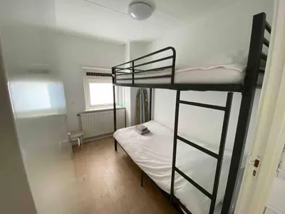 a small room with two bunk beds in it at Nice Spacious House Near Amsterdam And Schiphol in Zwanenburg