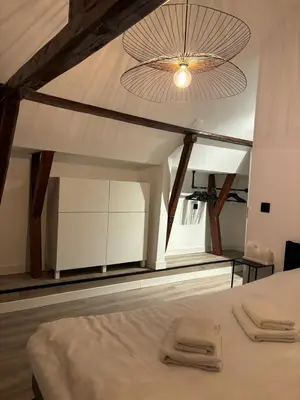 a bedroom with a white bed with a large ceiling at Luxury 6pers appartement Abcoude in Abcoude